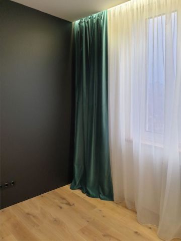 Текстильный декор для гостиной: шторы бархатные изумрудного цвета и белый тюль